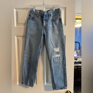 Levi’s 501 jeans in light blue wash with small distressed patches size 25